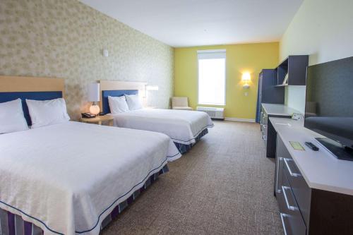 a hotel room with two beds and a desk at Home2 Suites by Hilton Brownsville in Brownsville