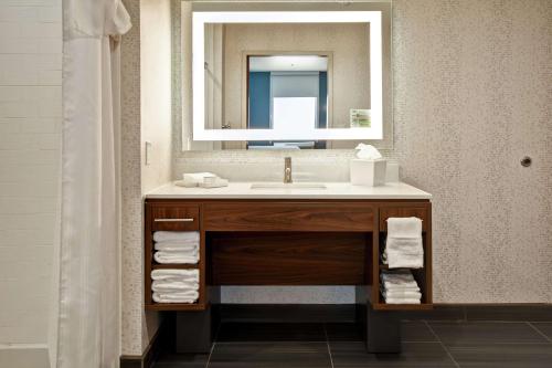 a bathroom with a sink and a mirror at Home2 Suites By Hilton Oklahoma City Airport in Oklahoma City