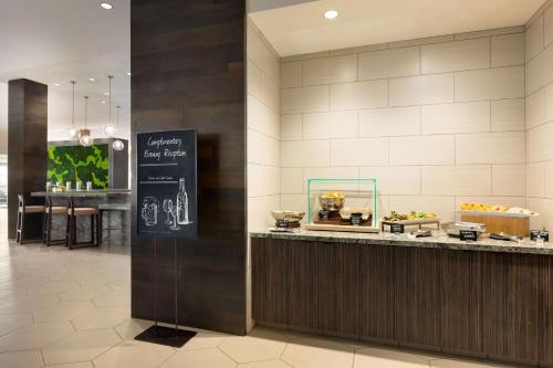 a restaurant with a counter with a buffet of food at Embassy Suites By Hilton San Antonio Landmark in San Antonio