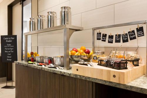 a buffet line with fruits and vegetables on a counter at Embassy Suites By Hilton San Antonio Landmark in San Antonio