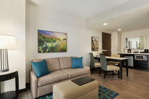 a living room with a couch and a table at Embassy Suites By Hilton San Antonio Landmark in San Antonio