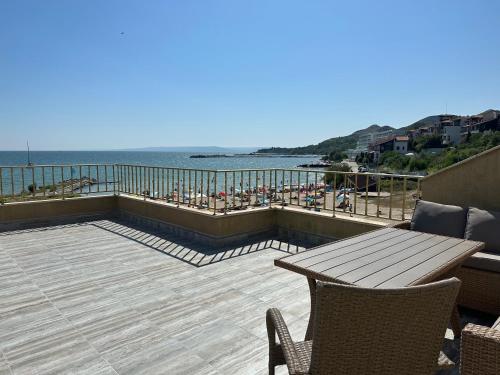a patio with a table and chairs and the ocean at 25m FROM THE BEACH!! Luxury Sea Paradise Apartment in Kavarna