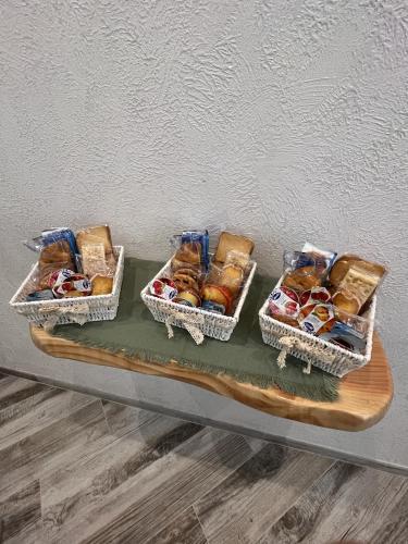 three baskets of different types of pastries on a table at Suites Matteotti 57 in Civitavecchia