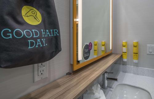 a bathroom with a sign that says good hair day at Tru by Hilton Garland Richardson in Garland