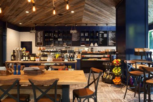 a restaurant with a table and chairs and a bar at The Porter Portland, Curio Collection By Hilton in Portland
