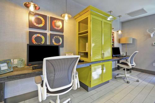 an office with a desk with a computer and two chairs at Home2 Suites by Hilton KCI Airport in Kansas City