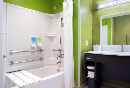 a bathroom with a bath tub and a sink at Home2 Suites By Hilton Indianapolis Greenwood in Indianapolis