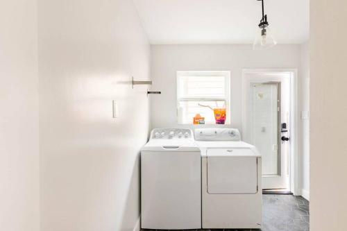 a white kitchen with a white stove top oven at Beach Home W AC- 5 BR - Free Parking - EV Charge in San Diego