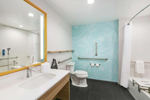 a bathroom with a toilet and a sink at Tru By Hilton Williamsville Buffalo Airport in Williamsville