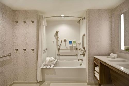 a bathroom with a tub and a shower and a sink at Home2 Suites by Hilton Kansas City KU Medical Center in Kansas City