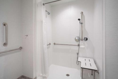 a bathroom with a shower with a toilet and a sink at Hilton Garden Inn Las Vegas City Center in Las Vegas