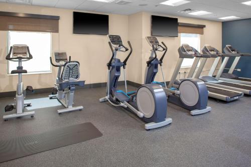 a gym with several tread machines in a room at Hampton Inn & Suites Chicago-Burr Ridge in Burr Ridge