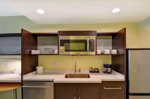 a kitchen with a sink and a microwave at Home2 Suites By Hilton Hilton Head in Hilton Head Island