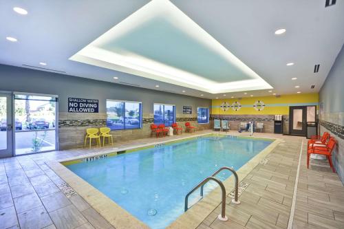 a pool in a hotel lobby with chairs and tables at Tru By Hilton Sumter in Sumter