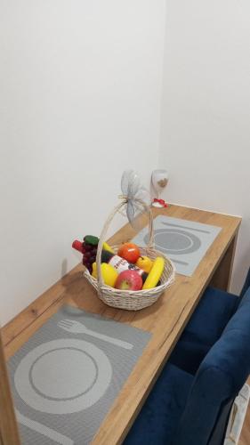 a basket of fruits and vegetables on a table at STAN NA DAN BIJELJINA in Bijeljina