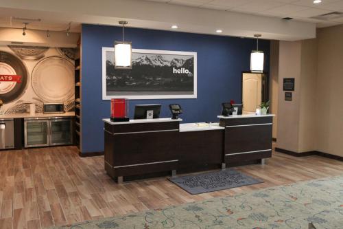 a hair salon with a blue wall at Hampton Inn & Suites Lafayette in Lafayette