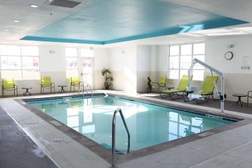 a large swimming pool with chairs and tables at Hampton Inn & Suites Lafayette in Lafayette