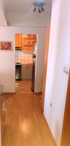 an empty room with a kitchen and a hallway at Exclusive Skopje Apartments in Skopje