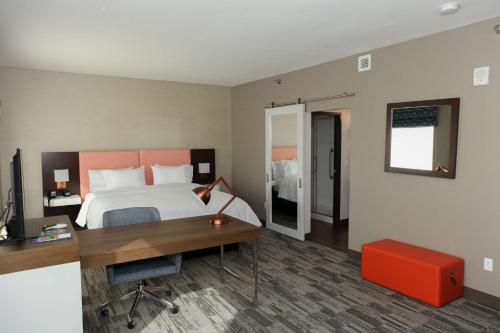 a hotel room with a bed and a desk and a desk at Hampton Inn & Suites Lafayette in Lafayette