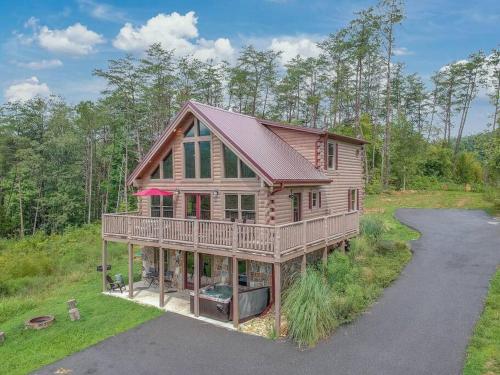 a log home with a wrap around porch and a driveway at Good Times 2 - Family Lodge-Fire Pit, Theater, Hot Tub & Pool Table in Sevierville