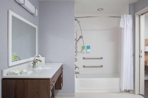 a white bathroom with a sink and a shower at Home2 Suites by Hilton Bloomington in Bloomington