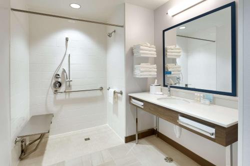 a white bathroom with a sink and a mirror at Hampton Inn & Suites Rexburg in Rexburg