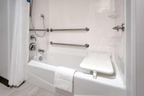 a white bathroom with a bath tub and a toilet at Hampton Inn & Suites Rexburg in Rexburg