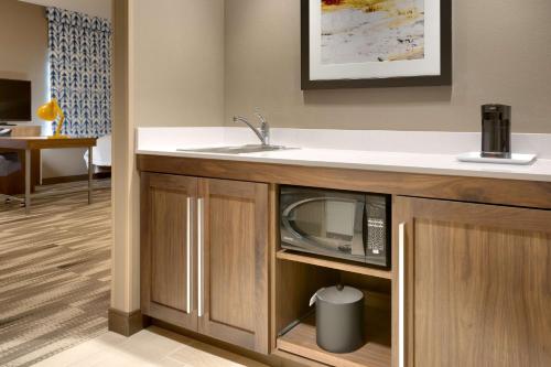 a kitchen with a sink and a microwave at Hampton Inn & Suites Rexburg in Rexburg