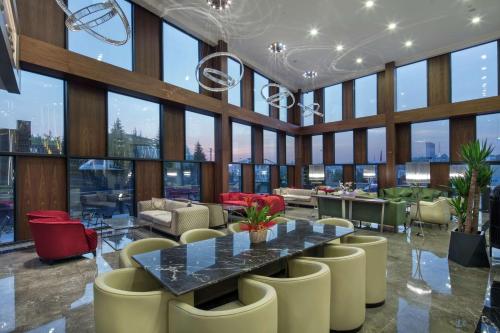 a large room with a table and chairs and windows at Hilton Garden Inn Yalova in Yalova