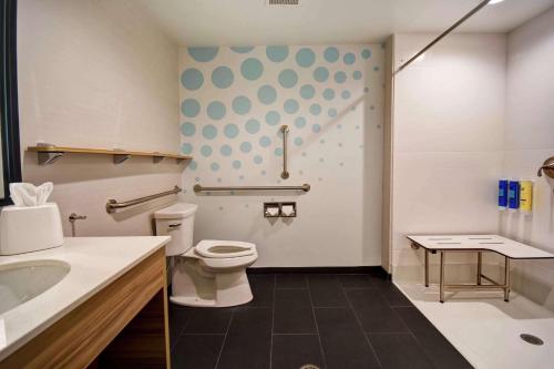 a bathroom with a toilet and a sink at Tru By Hilton North Platte in North Platte