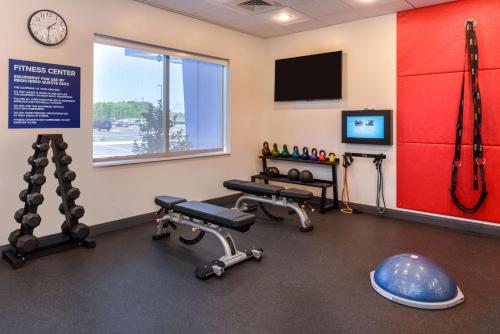 a fitness room with two tread machines and a clock at Tru By Hilton Little Rock West in Little Rock