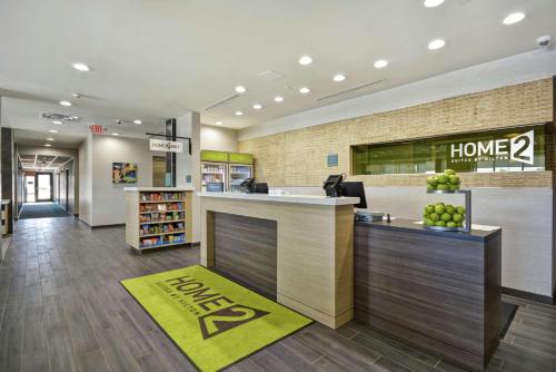 a lobby of a store with a home sign on the wall at Home2 Suites By Hilton Texas City Houston in Texas City
