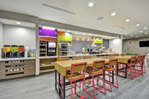 a fast food restaurant with a table and chairs at Home2 Suites By Hilton Texas City Houston in Texas City