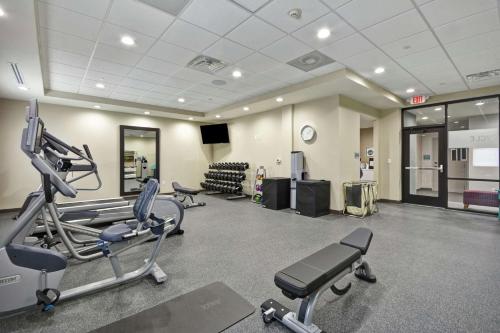 a gym with treadmills and machines in a room at Home2 Suites By Hilton Texas City Houston in Texas City