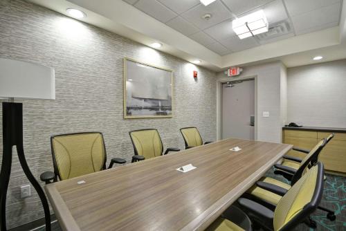 a conference room with a wooden table and chairs at Home2 Suites By Hilton Texas City Houston in Texas City