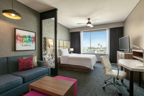 a hotel room with a bed and a couch at Homewood Suites By Hilton Monterrey Apodaca in Monterrey