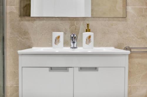 a white bathroom sink with two paper towels on it at Nice studio Bart 50 meters from Playa Las Vistas in Arona