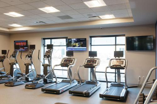 a gym with a row of cardio machines at Hilton Garden Inn Madison Sun Prairie in Sun Prairie
