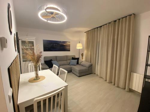 a living room with a couch and a table at Apartaments L’ARC in Palafrugell