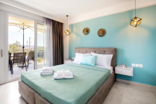 a bedroom with a bed with two towels on it at Otium Studios in Limenaria