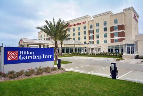 a hotel with a sign in front of a building at Hilton Garden Inn Houston Hobby Airport in Houston