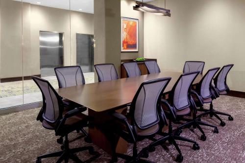 a conference room with a wooden table and chairs at Hilton Garden Inn Waco in Waco