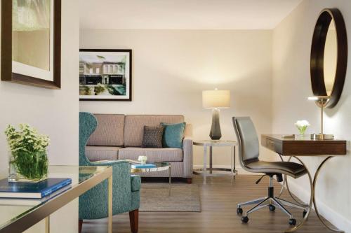 a living room with a couch and a desk at Hotel Ballast Wilmington, Tapestry Collection by Hilton in Wilmington