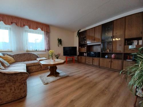 a living room with a couch and a table at Haseltal in Suhl
