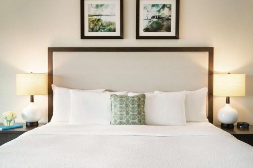 a bedroom with a large white bed with two lamps at Hotel Ballast Wilmington, Tapestry Collection by Hilton in Wilmington