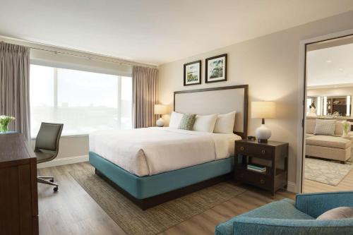 a hotel room with a bed and a desk and a chair at Hotel Ballast Wilmington, Tapestry Collection by Hilton in Wilmington