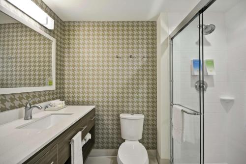 a bathroom with a toilet and a sink and a shower at Home2 Suites By Hilton Plymouth Minneapolis in Plymouth