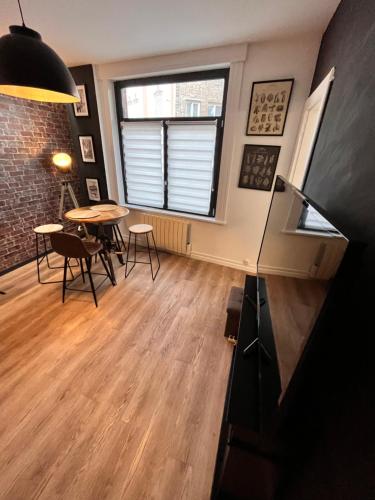 a living room with a table and chairs and a window at North cosy house - Douai Centre in Douai