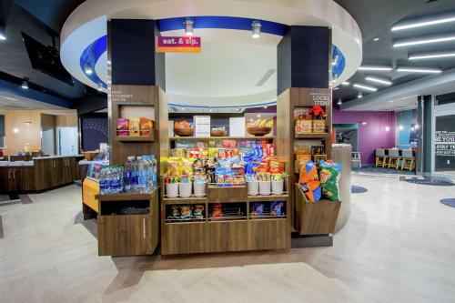 a store with a display of food and drinks at Tru by Hilton Lafayette River Ranch in Lafayette