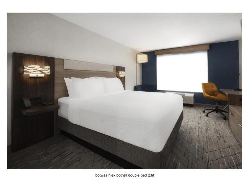 a bedroom with a large white bed and a desk at Holiday Inn Express Bothell by IHG in Bothell